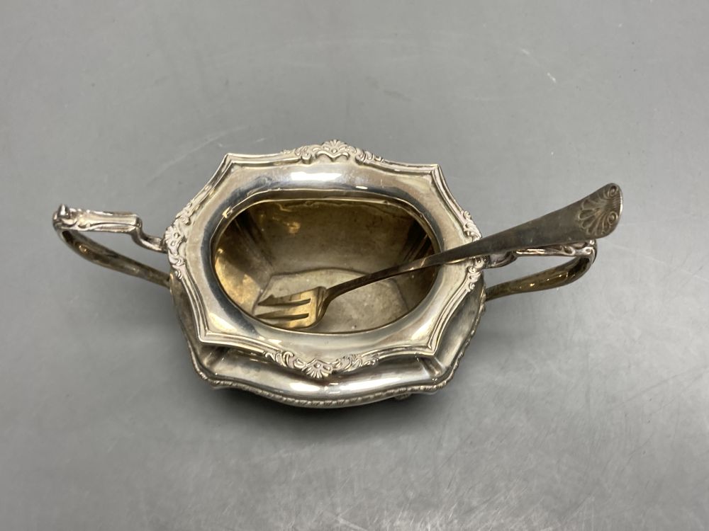 A George V silver bachelors three piece tea set, Josiah Williams & Co, London, 1913 and a silver pickle fork,